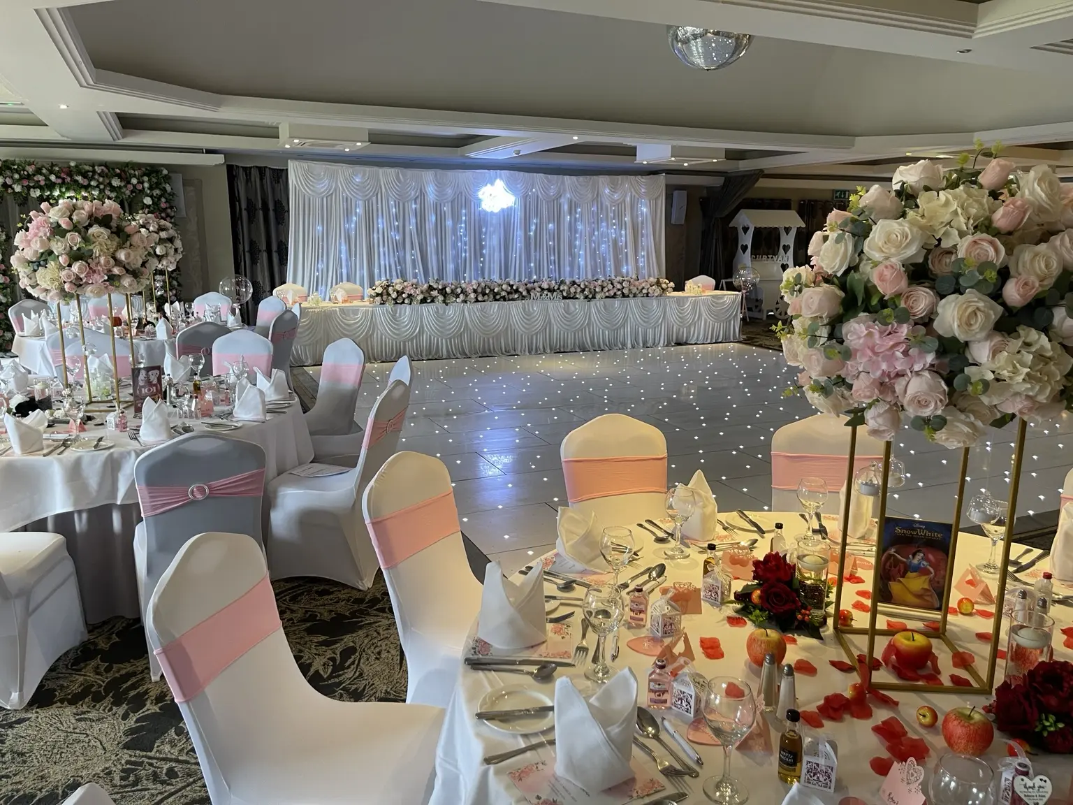 Wedding room styled with an Instapic LED backdrop and white dance floor