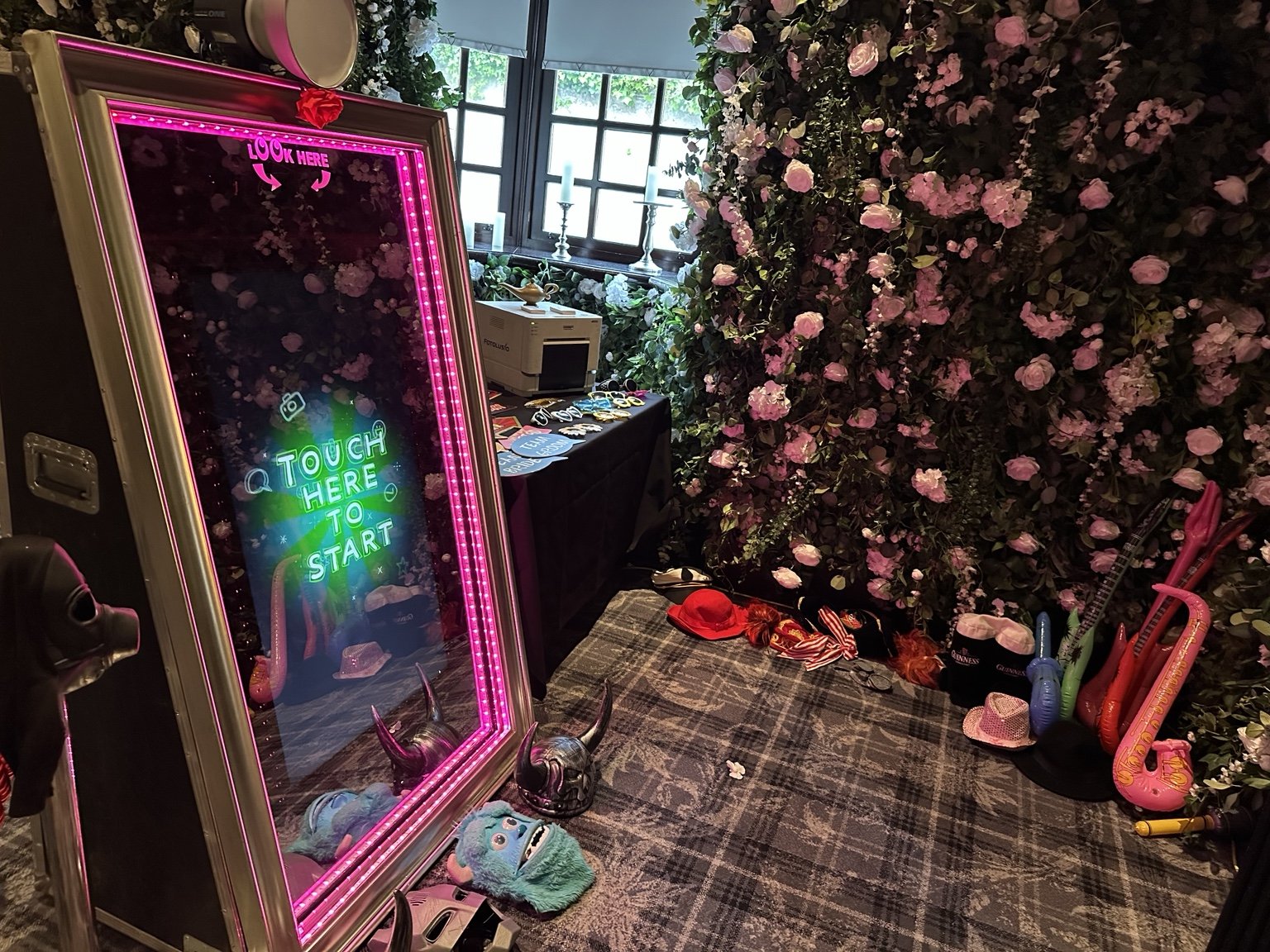 Magic mirror wedding setup with flower wall and guest props