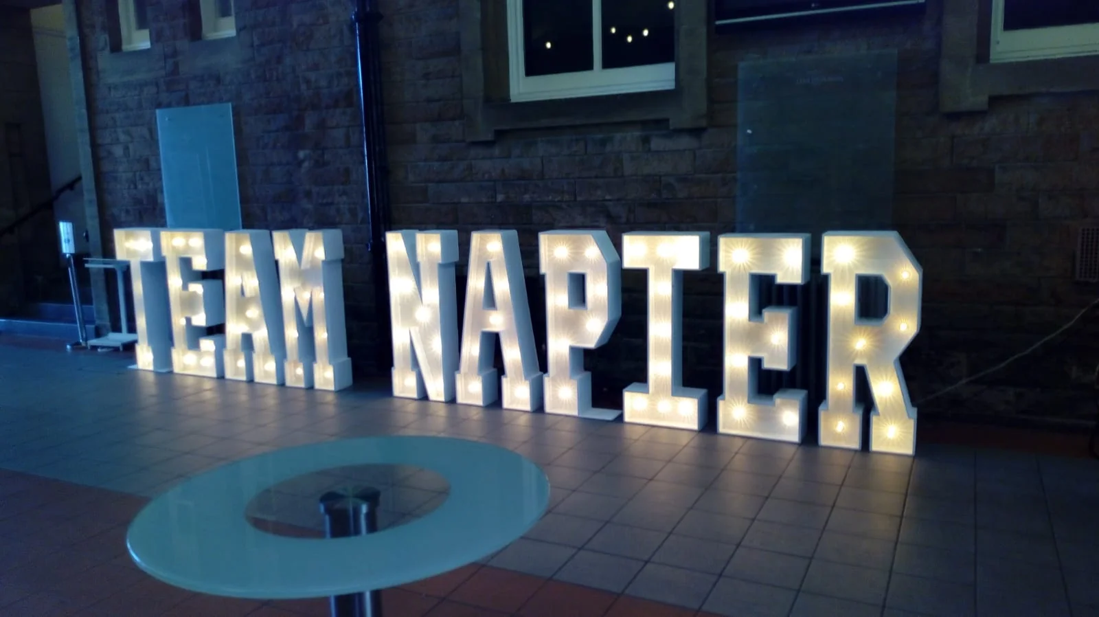 Full TEAM NAPIER illuminated light-up letter display at a Scottish corporate event