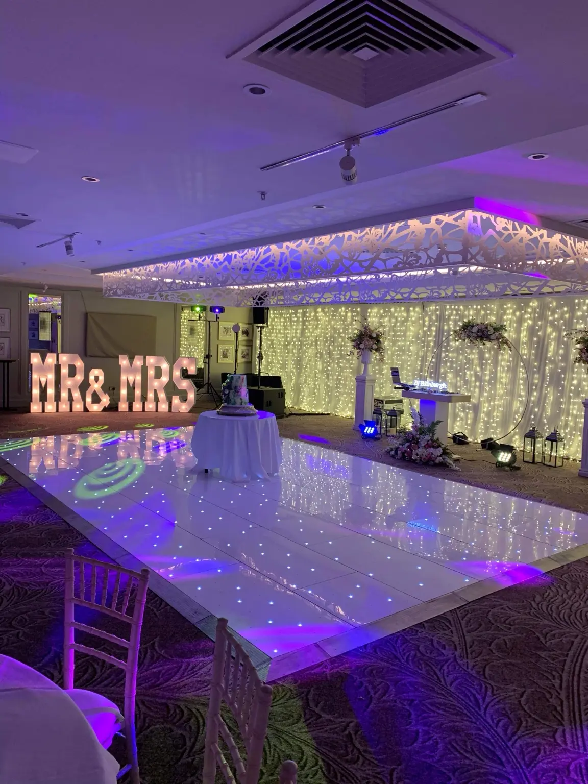 Purple-lit wedding reception with an Instapic LED dance floor and illuminated letters
