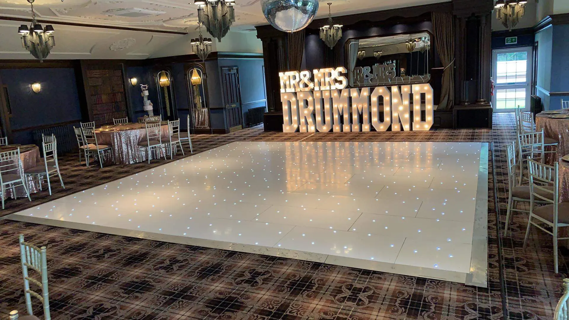 Large white LED dance floor filling a wedding reception room