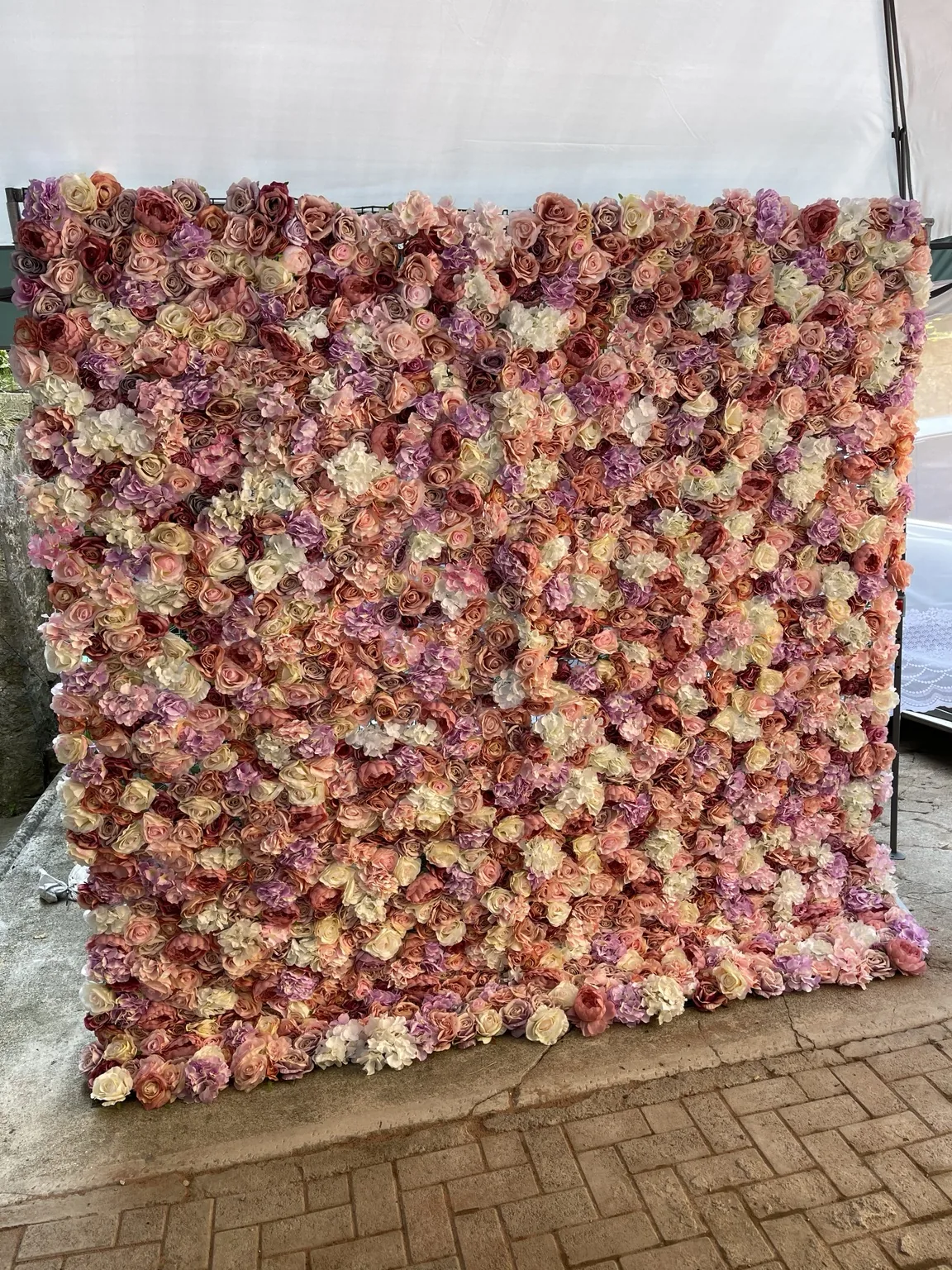 Close view of a pastel flower wall with blush and ivory blooms