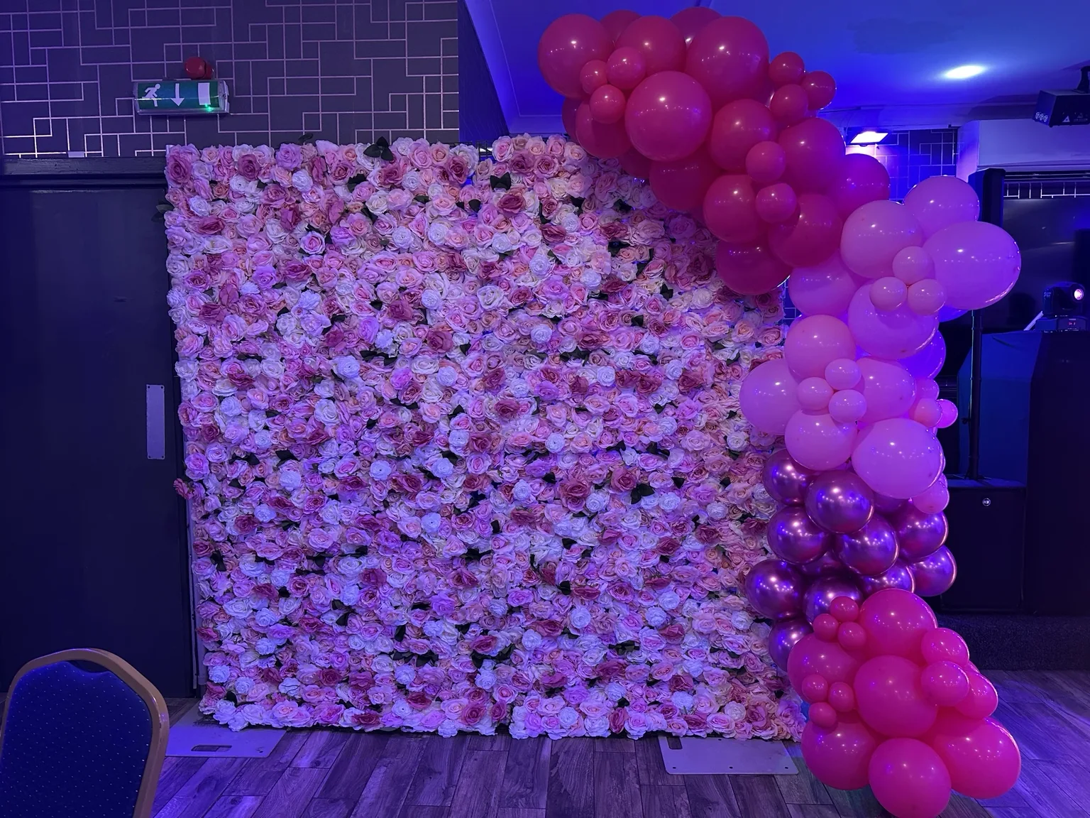 Pink flower wall paired with a balloon garland