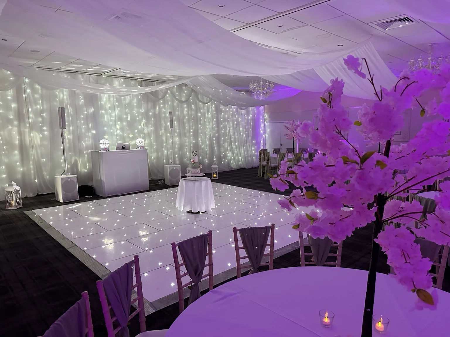 White LED dance floor illuminated by purple evening lighting