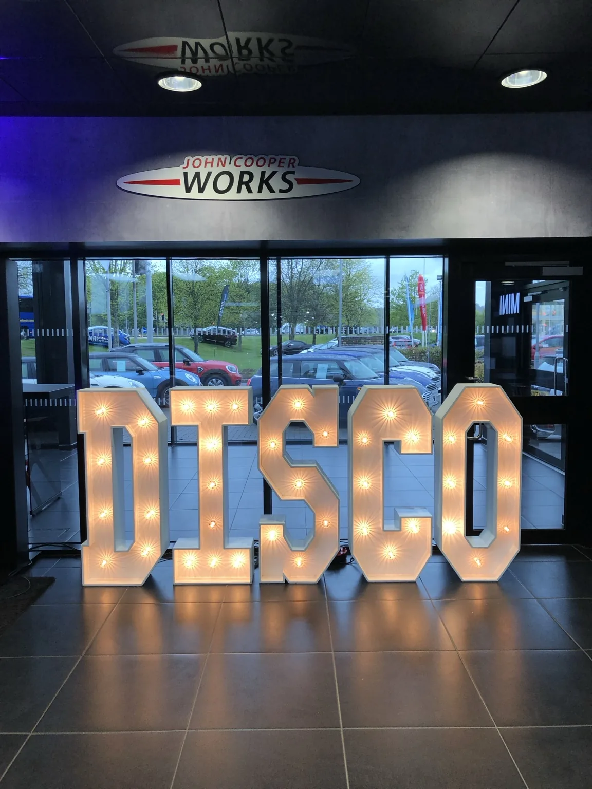 Large DISCO illuminated letters at an evening event