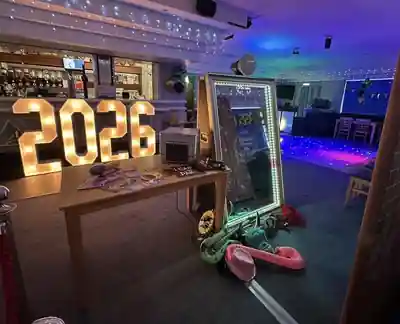 Instapic Magic Mirror set up with illuminated 2026 numbers, props and an LED dance floor at an event