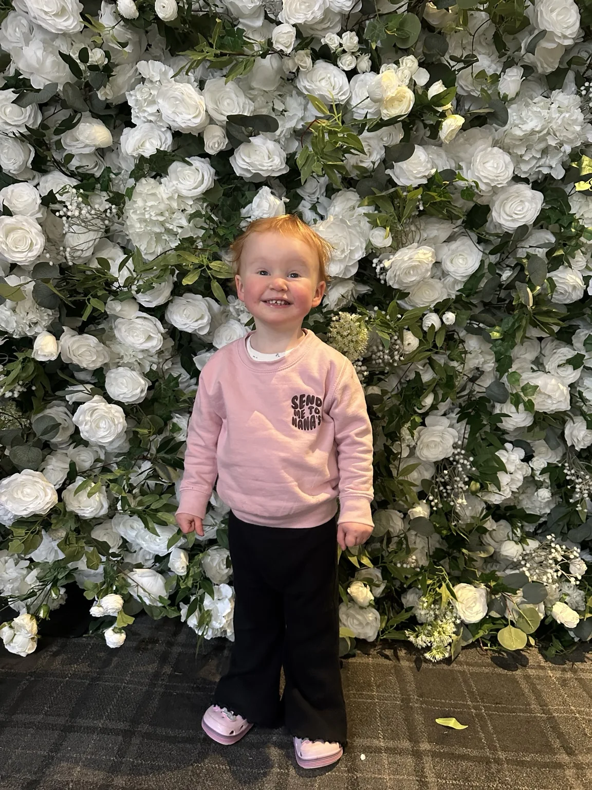 Flower wall at Barony Castle Hotel Guest in front of an Instapic floral backdrop at Barony Castle Hotel