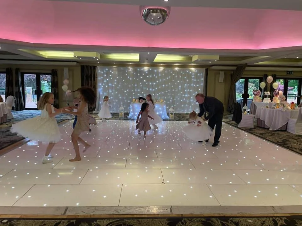 Guests using the large white starlit dance floor at Dalziel Park