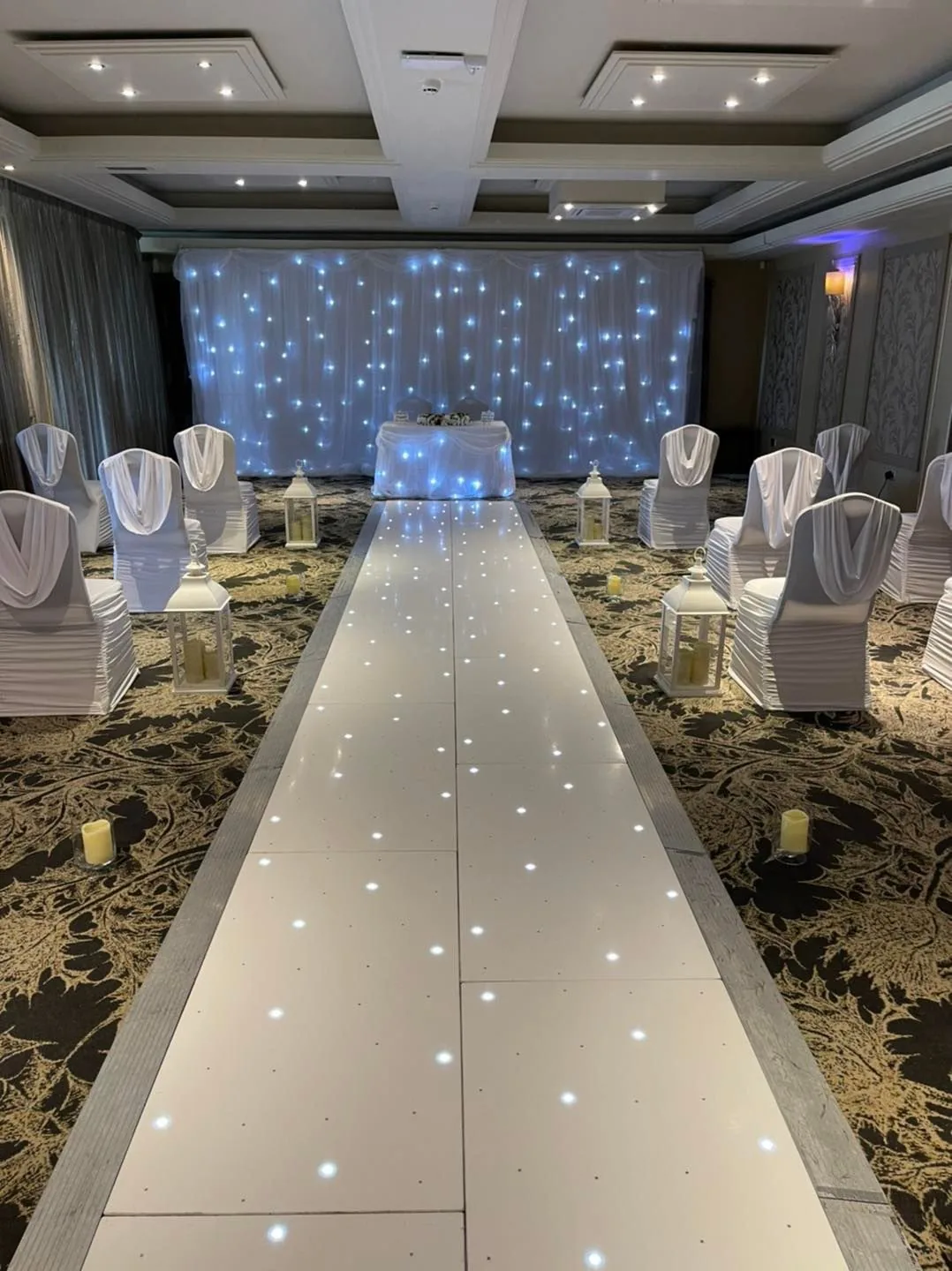 Starlit wedding aisle at Dalziel Park Starlit white wedding aisle and LED backdrop at Dalziel Park