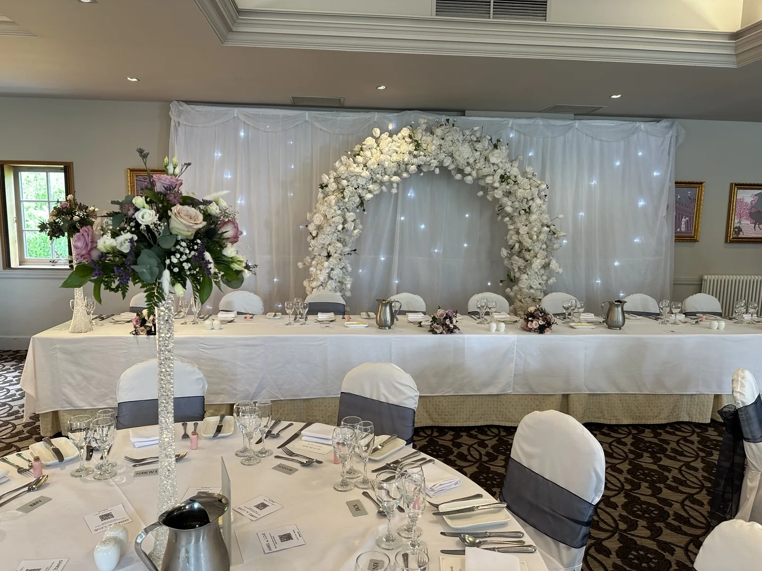 White floral arch and top-table wedding styling at The Hilcroft Hotel Whitburn