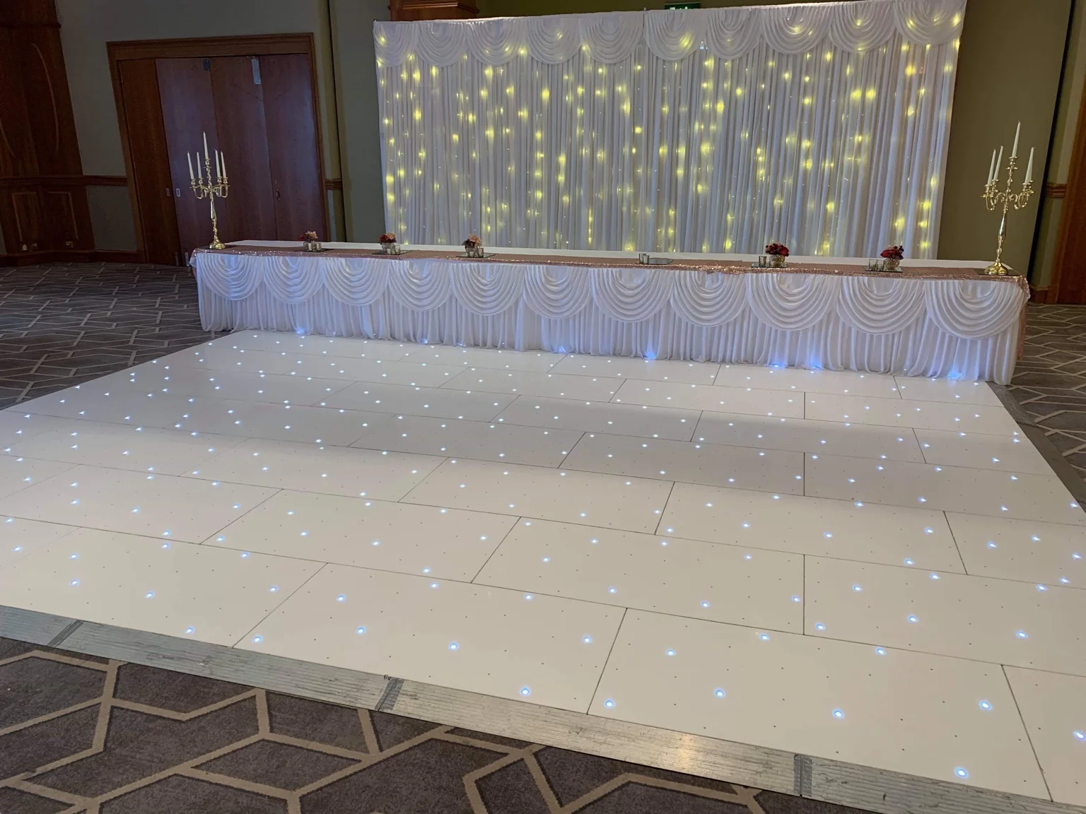 White LED dance floor and starlit top-table backdrop at The Hilcroft Hotel