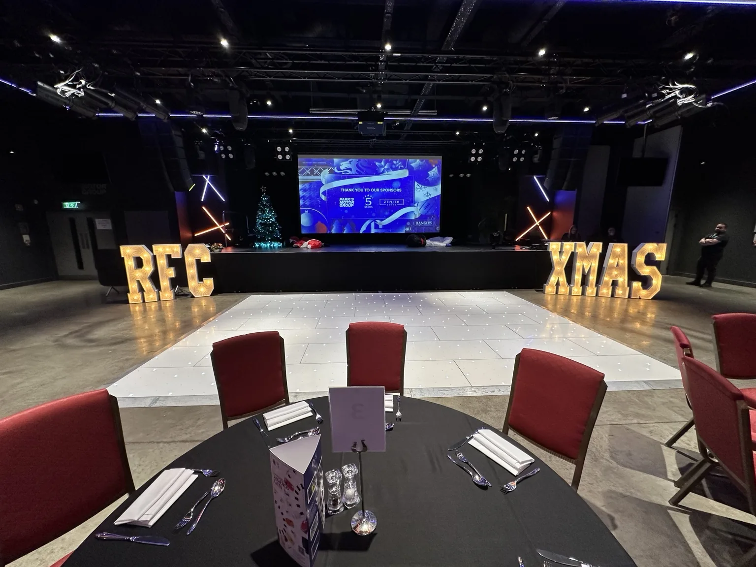 Wide Edmiston House event setup with white starlit dance floor and illuminated letters