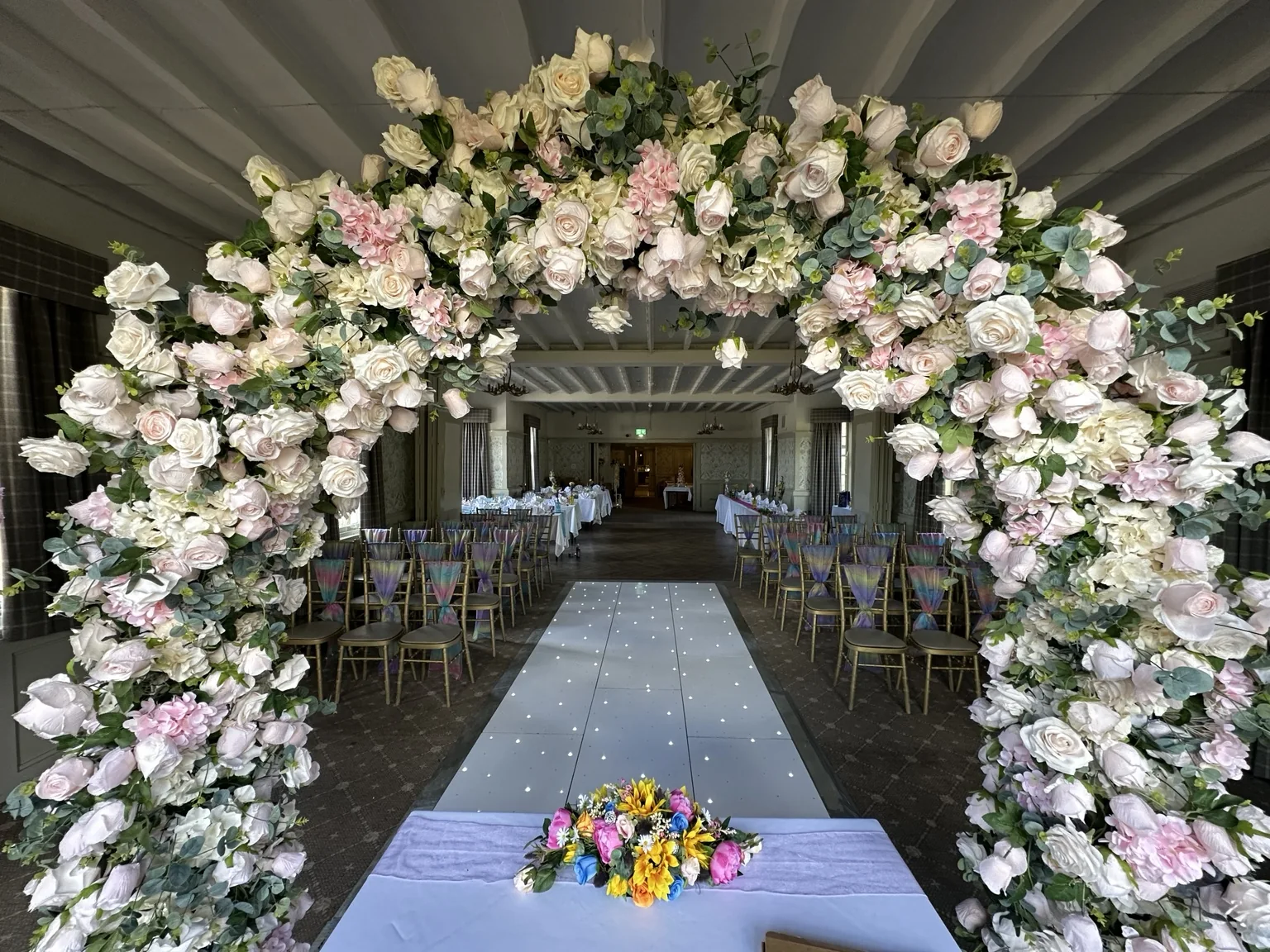 Floral arch at The Stair Arms Hotel Blush floral arch framing a wedding ceremony at The Stair Arms Hotel