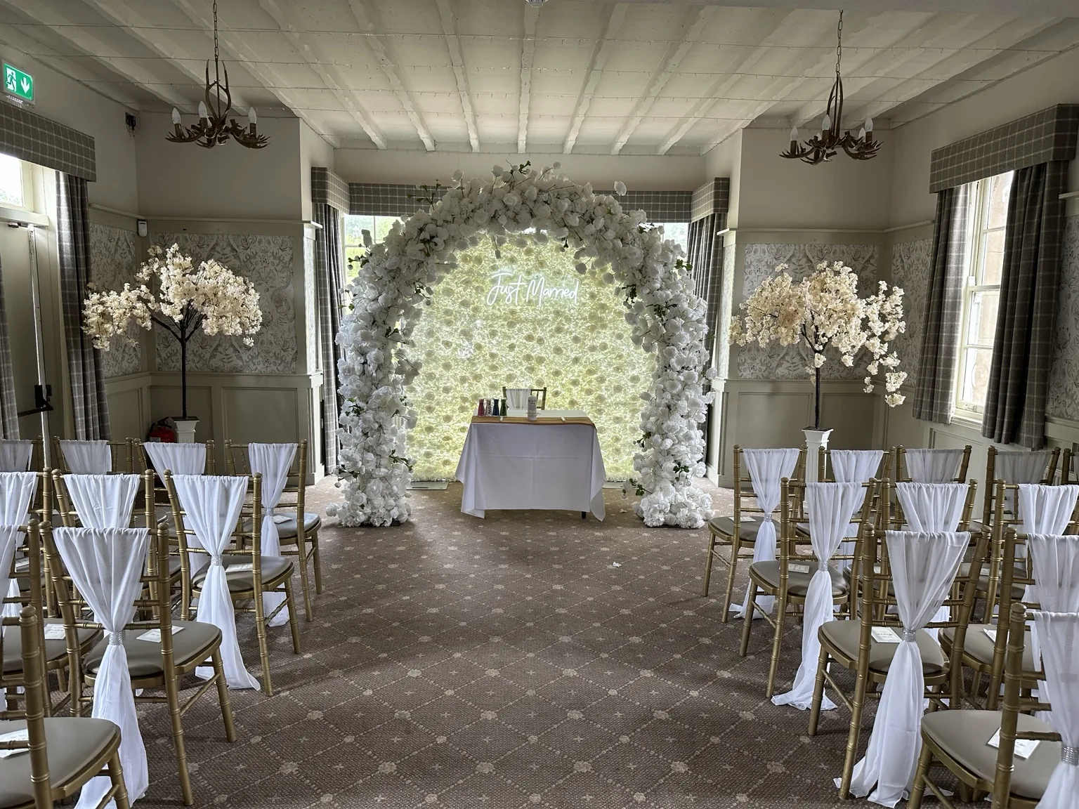 White floral arch at The Stair Arms Hotel White floral arch and ceremony seating at The Stair Arms Hotel