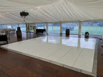 20 by 20 foot white starlit LED dance floor installed inside The Seton Garden marquee