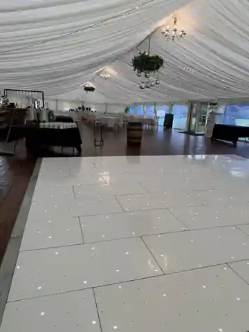Wide interior view of The Seton Garden marquee with an Instapic white starlit dance floor
