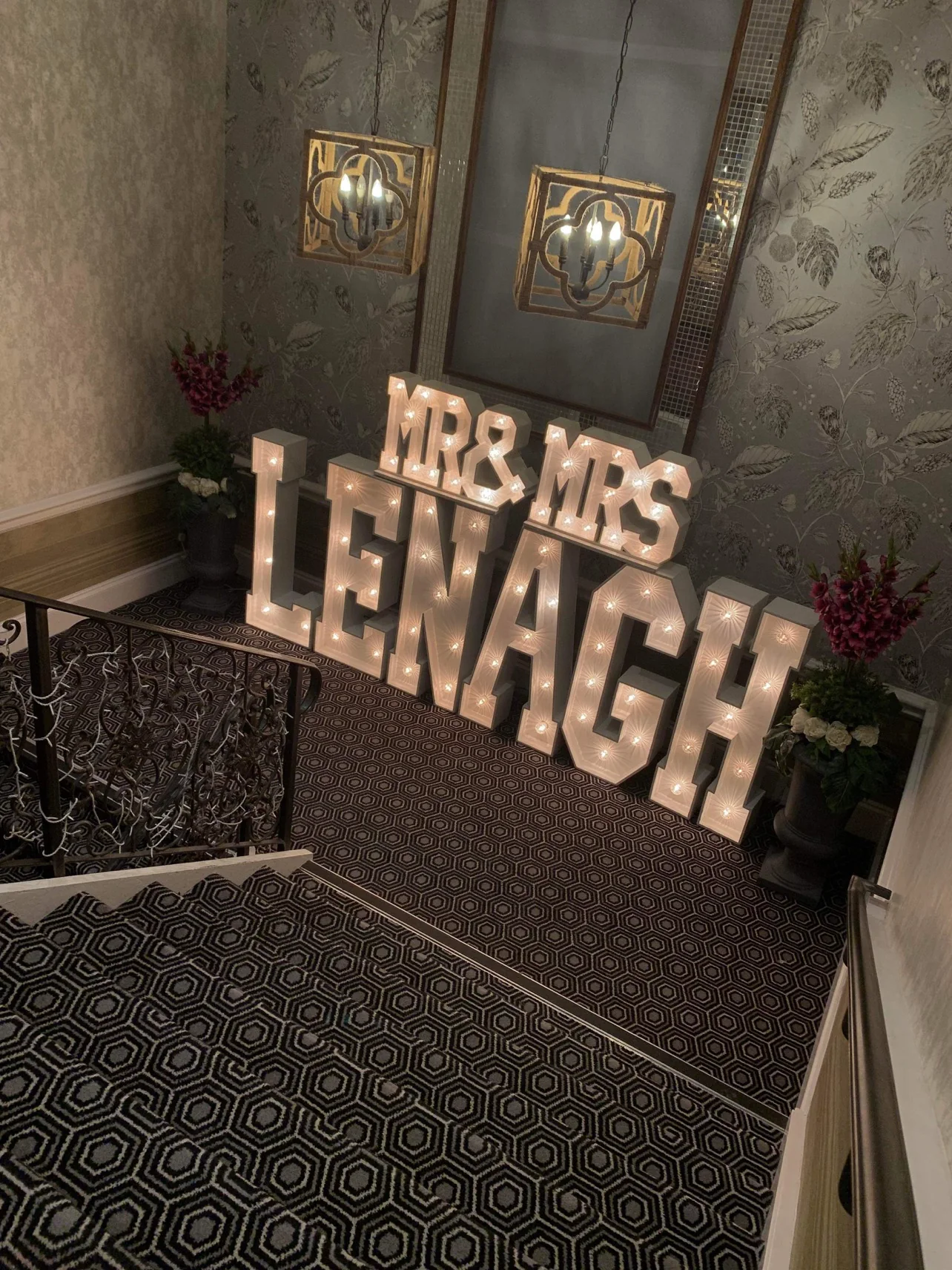 Personalised LENAGH illuminated wedding letters on the staircase at The Tudor Hotel Airdrie