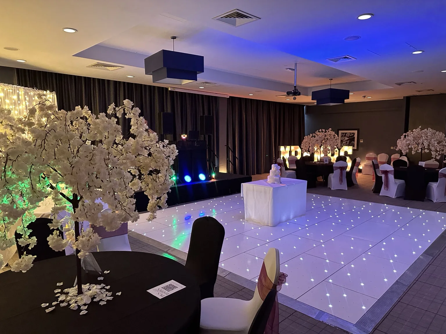 Starlit LED dance floor framed by blossom trees at Village Hotel Edinburgh