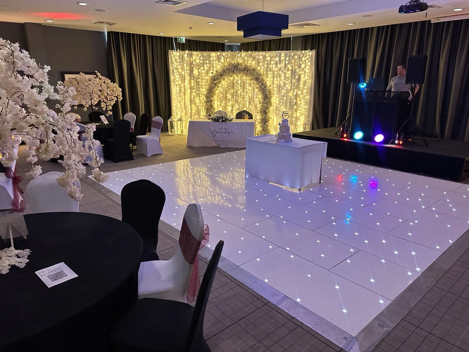 LED dance floor with floral backdrop and event styling at Village Hotel Edinburgh