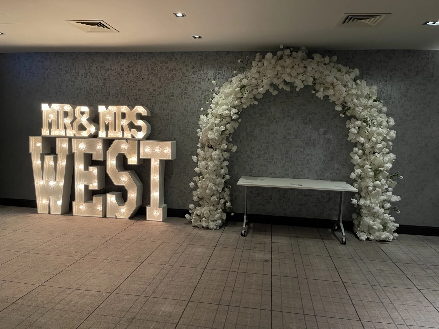 Personalised WEST light-up letters and floral arch at Village Hotel Edinburgh